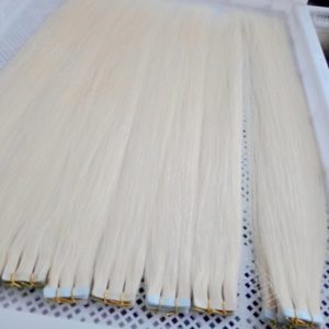 Platinum blonde tape hair extensions